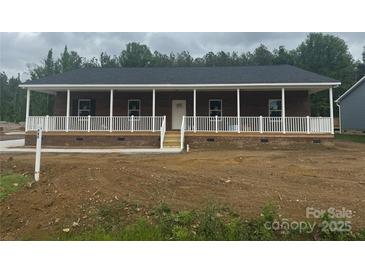 Charming single-story brick home with a welcoming covered front porch and white railings at 745 Grier St, Rock Hill, SC 29730