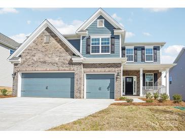 Beautiful two-story home with a two-car garage and brick and siding exterior at 5108 Silver Creek Ln, Denver, NC 28037