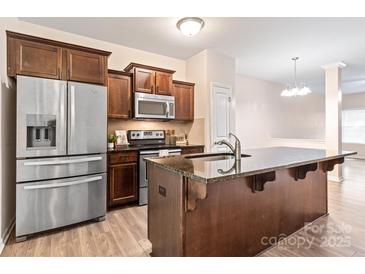 Modern kitchen features stainless steel appliances and an island at 1002 Tj Dr, Monroe, NC 28112