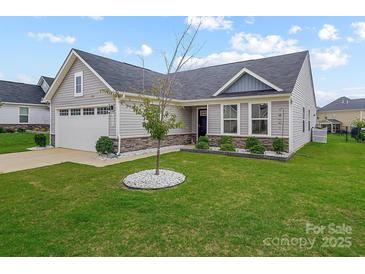 Charming single-story home with well-manicured lawn, stone accents, and attached garage, offering great curb appeal at 4280 Stream Dale Cir, Concord, NC 28027