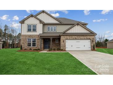 Two-story house with brick and siding exterior, a large yard, and a two-car garage at 116 Brooke Forest Ct, Mooresville, NC 28115