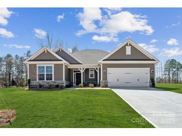 Charming single-story home with a well-manicured lawn and inviting two-car garage, creating instant curb appeal at 120 Brooke Forest Ct, Mooresville, NC 28115
