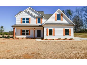 Two-story house with white siding, brown roof, and orange shutters at 7805 Medlin Rd, Monroe, NC 28112