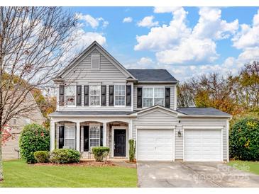 Charming two-story home with a well-maintained lawn and attached two-car garage at 2715 Ballade Dr, Matthews, NC 28105