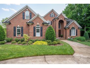 Charming brick home featuring manicured landscaping, arched windows, and a welcoming front entrance at 2840 Wheat Field Ct, Lincolnton, NC 28092