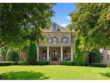 Brick two-story house with a large front porch and manicured lawn at 308 Montrose Dr, Waxhaw, NC 28173