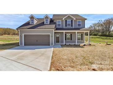 Charming two-story home with a two-car garage and a well-maintained front yard at 4122 Old Monroe Marshville Rd, Wingate, NC 28174