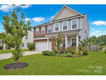 Two-story brick home with attached garage and landscaped front yard at 129 Eden Ave, Mooresville, NC 28115