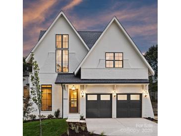 Beautiful two-story white brick home with a two-car garage and manicured landscaping at 5022 Ohm Ln, Charlotte, NC 28270