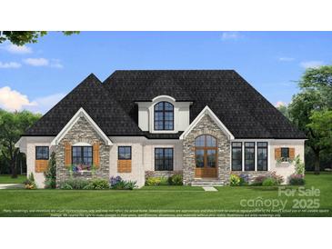 Charming home showcasing stone and white brick, complemented by manicured lawn and beautiful landscaping at 00 Mcfalls Ln # 02, Indian Land, SC 29707
