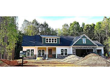 Charming single Gathering home with a mix of stone and vinyl siding and an attached two-car garage at 1025 Baylor Grv, Monroe, NC 28112