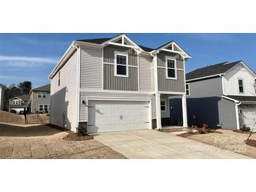 Charming two-story home featuring a white garage door and neutral siding in a suburban neighborhood at 157 Shepherds Landing Dr, Mooresville, NC 28115