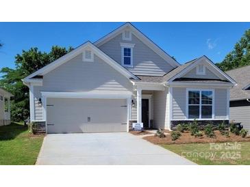 Two-story Craftsman home with neutral siding and a two-car garage at 131 Sari St, Troutman, NC 28166