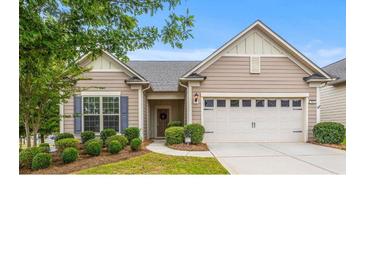 Charming single-story home featuring manicured landscaping, a two-car garage and a welcoming entrance at 984 Kirby Dr, Fort Mill, SC 29715
