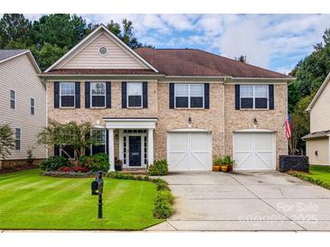 Brick two-story house with a two-car garage and landscaped front yard at 6421 Chadwell Ct # 61, Fort Mill, SC 29707