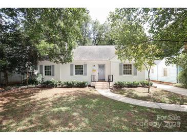 Charming white brick home with gray shutters and landscaped lawn at 1422 Morningside Dr, Charlotte, NC 28205