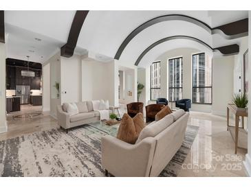 Spacious living area with arched ceilings and city views at 127 Tryon N St # 503, Charlotte, NC 28202