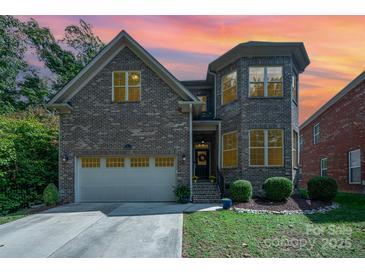 Brick house with a two-car garage and landscaped lawn at 7954 Rolling Creek Ct, Charlotte, NC 28270