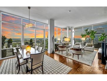 Bright, open living space with floor-to-ceiling windows and hardwood floors at 215 N Pine St # 3705, Charlotte, NC 28202