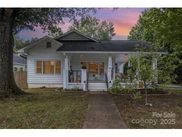 Charming white house with a porch and well-manicured lawn at 317 Kerr Nw St, Concord, NC 28025