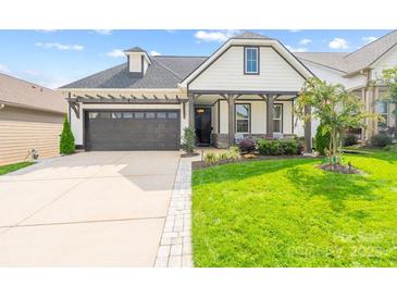 Craftsman style home with white siding, dark gray garage door, and a landscaped lawn at 494 Bowline Dr, Denver, NC 28037