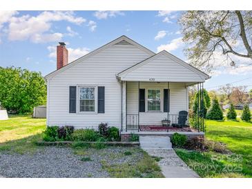 Charming single-Gathering home featuring black shutters, a brick chimney, and a cozy front porch with rod iron railings at 630 S Myrtle School Rd, Gastonia, NC 28052