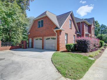 Attached two-car garage with a concrete driveway and manicured landscaping at 907 Weymouth Dr, Gastonia, NC 28056