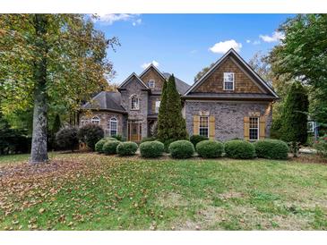 Brick two-story house with landscaped lawn and mature trees at 4800 Pimlico Ln, Waxhaw, NC 28173