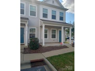 Two-story townhome with gray siding, front porch, and landscaping at 13969 Clayborn St, Midland, NC 28107