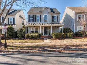 Two-story house with gray siding, a covered porch, and landscaping at 11612 Kingsley View Dr, Charlotte, NC 28277