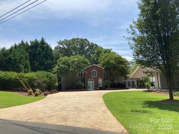 Charming brick and siding home with mature trees and a spacious driveway at 24756 Strand Dr, Albemarle, NC 28001
