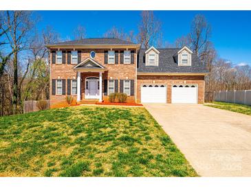 Lovely two-story brick home featuring a well-manicured lawn and an attached three-car garage at 2640 Ironwood Dr, Hickory, NC 28602