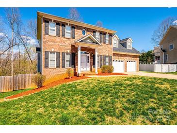 Charming two-story home with a brick facade, three-car garage, and manicured lawn at 2640 Ironwood Dr, Hickory, NC 28602