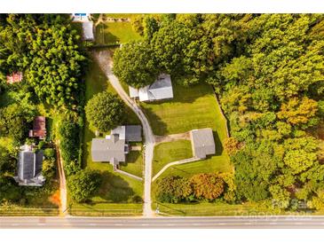 Expansive aerial view of property featuring multiple structures amidst lush greenery and a long driveway at 5960/5930 S Main St, Salisbury, NC 28147