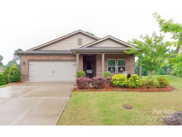 Charming brick home featuring a well-maintained lawn and a two-car garage at 2413 Riparian Way, Denver, NC 28037