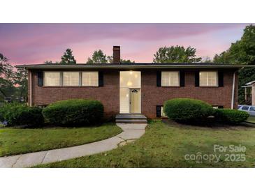 Brick ranch house with landscaped yard and walkway at 3327 Deerwood Dr, Gastonia, NC 28054