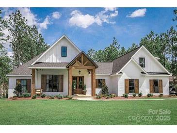 Charming two-story home with a manicured lawn and beautiful architectural details at 414 E Glenview Dr, Salisbury, NC 28147