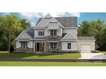 Charming two-story home featuring stone accents, symmetrical windows, and a well-manicured front lawn at 8111 Farm Crossing Ln # 2, Huntersville, NC 28078