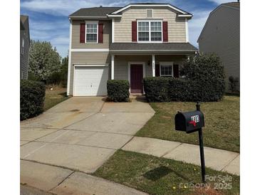 Charming two-story home featuring a garage and well-maintained front yard at 4803 Roxfield Ln, Charlotte, NC 28215