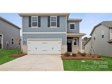 Two-story house with gray siding, white garage door, and landscaping at 538 Mountain View Dr, Monroe, NC 28110