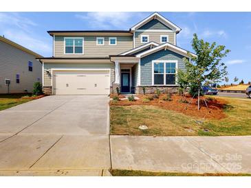 Two-story house with a two-car garage and landscaped front yard at 9912 Manor Vista Trl, Kannapolis, NC 28027