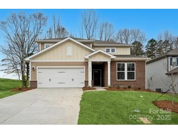 Charming two-story home with a two-car garage, brick facade, and well-manicured lawn at 9913 Manor Vista Trl, Kannapolis, NC 28027