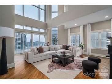 Luxury living room with hardwood floors and stunning city views at 520 E Martin Luther King Blvd # 1204, Charlotte, NC 28202