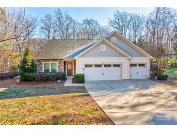 Gray two-story house with double garage and landscaped lawn at 7324 Friar Tuck Ln, Mint Hill, NC 28227