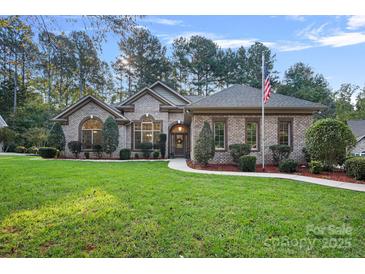 Brick ranch home with landscaped lawn and walkway at 115 Hawk Run Ln, Troutman, NC 28166