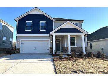 Two-story home with gray and blue siding, a white door, and a two-car garage at 3014 Cunningham Farm Dr, Indian Trail, NC 28079