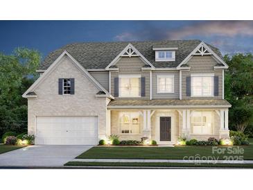 Two-story house with a brick and shingle exterior, a three-car garage, and landscaping at 123 Kepli Way # 12, Mooresville, NC 28115