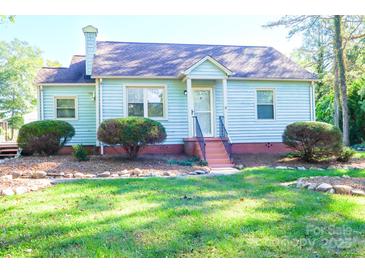 Charming light blue house with a well-manicured lawn at 1350 8Th Nw St, Hickory, NC 28601