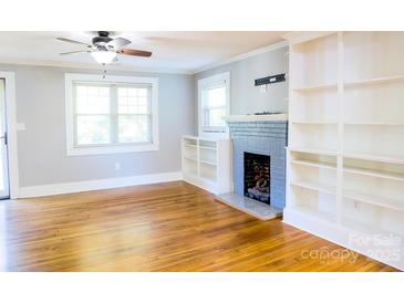 Bright living room with hardwood floors, built-in shelving, and fireplace at 1350 8Th Nw St, Hickory, NC 28601