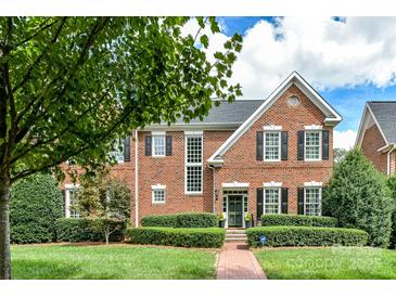 Brick two-story home with manicured lawn and walkway at 4813 Cambridge Crescent Dr, Charlotte, NC 28226